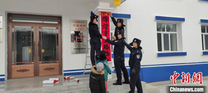 圖為恩和哈達(dá)邊境派出所民警貼對聯(lián)?！《骱凸_(dá)邊境派出所供圖